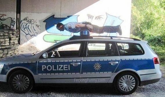 arrested-man-on-police-car-top