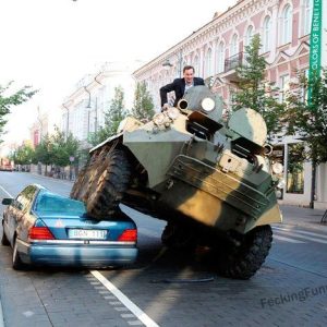 crazy--man-driving-tank-to-office-smasing-a-car