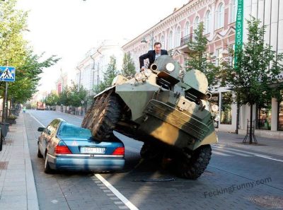 crazy--man-driving-tank-to-office-smasing-a-car