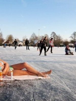 Bikini girl enjoying sunbath on snow