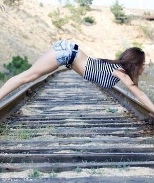Woman posing on railroad