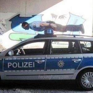 arrested-man-on-police-car-top