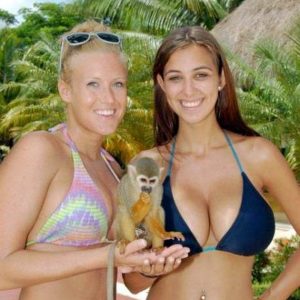 two-busty-women_in-beach-with-monkey